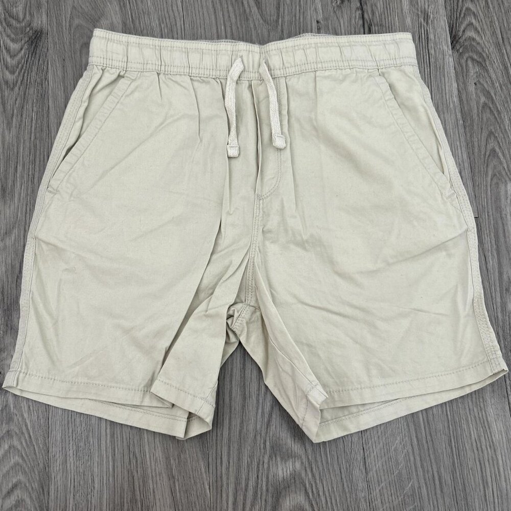 Cream and tan shorts with drawstring waistband, featuring a relaxed fit